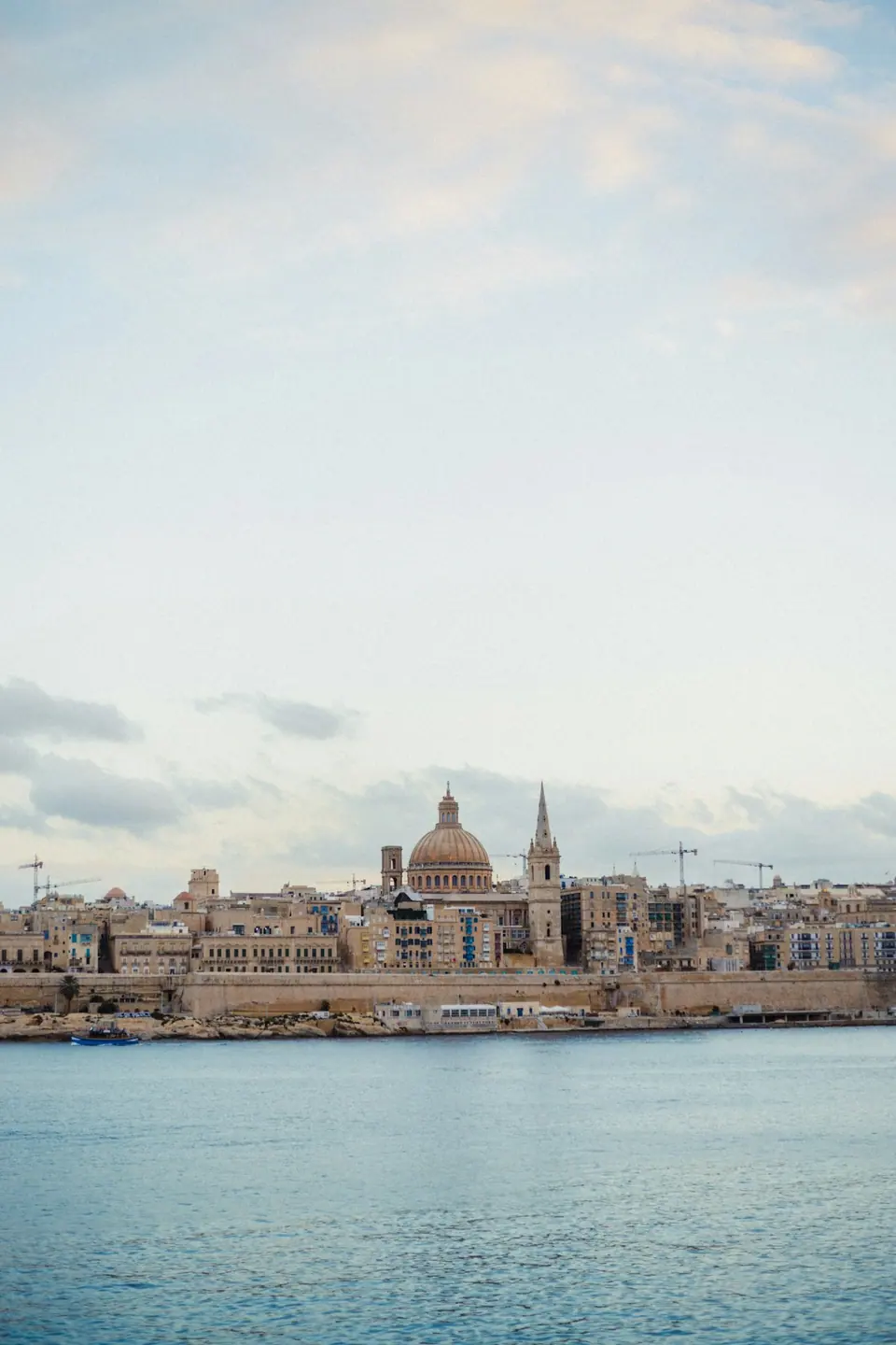 Valletta waterfront with its limestone buildings, dome and spire