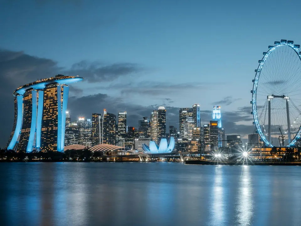 Marina Bay Sands and the Singapore Flyer reflected in Marina Bay at blue hour