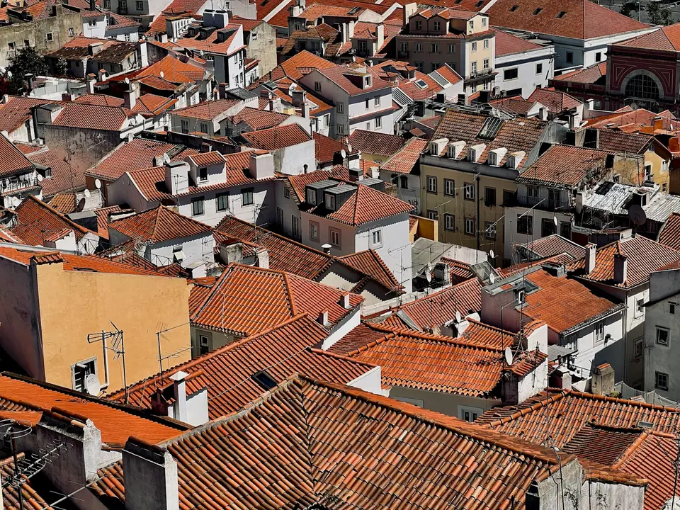 Sunlit Lisbon rooftops overlooking the Tagus River